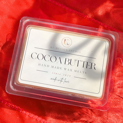 Top view of white cocoa butter wax melts in a six-heart tablet, featuring a creamy texture and a rich, comforting cocoa butter scent.