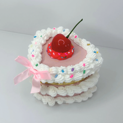 Heart-shaped white mini cake jewelry box with a soft pink bow—cute, classy, and perfect for storing your favorite accessories.