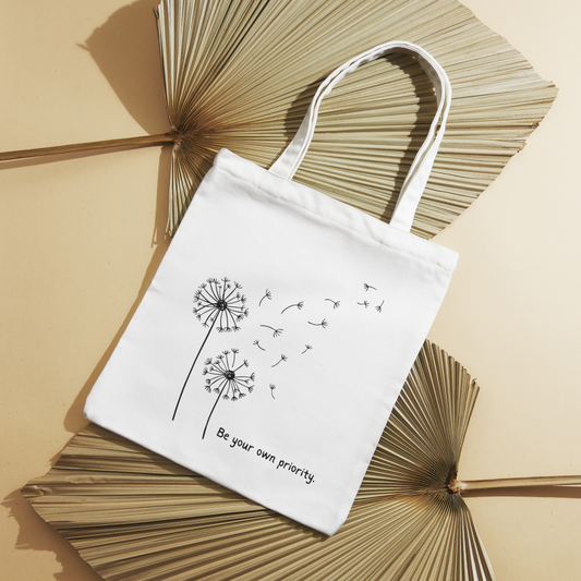 White Priority Canvas Tote Bag featuring a serene flower scene, built with durable 12oz canvas and reinforced stress points for long-lasting use.