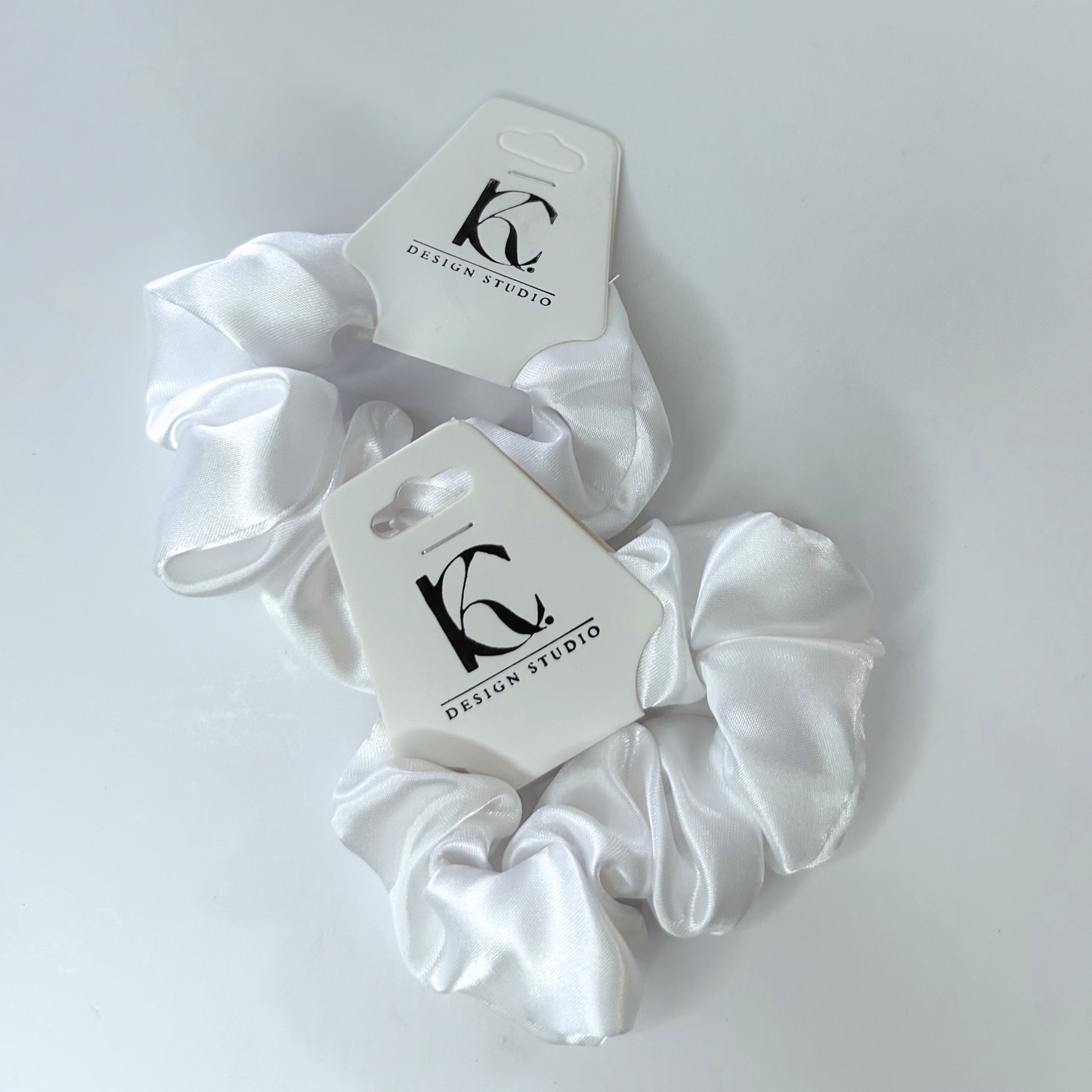 Classic white silk scrunchie perfect for a clean, elegant look.