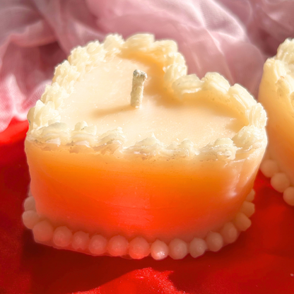 Side view of a white decorative vintage heart-shaped cake candle, showcasing its delicate frosting-like details and charming, romantic aesthetic.
